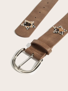 Detail of brown leather belt with silver buckle and star patch with leopard print