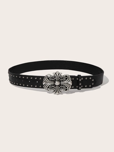 Close-up of gothic silver buckle with vintage floral engraving and metal studs on belt