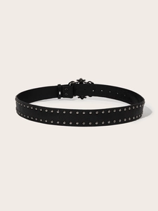 Macro detail of punk black leather belt with double rows of silver metal rivets and buckle