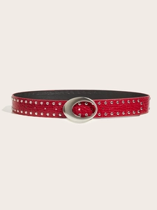 Detail of red crocodile textured leather belt featuring double rows of silver studs