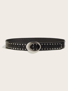 Detail of black crocodile texture belt with double rows of silver studs and oval buckle