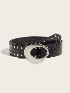 Detailed view of black crocodile pattern belt with silver oval buckle and metal rivets