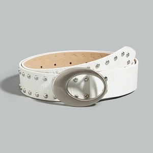 White faux crocodile skin belt with silver rivets and oval metal buckle in Y2K style