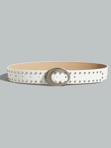 Detail of white embossed leather belt with silver moon buckle and metallic rivets