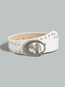 Macro shot of a white crocodile embossed leather belt with silver rivets and oval buckle
