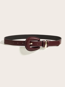 Close-up of deep burgundy leather belt with a wrapped buckle and gold metal ring detail