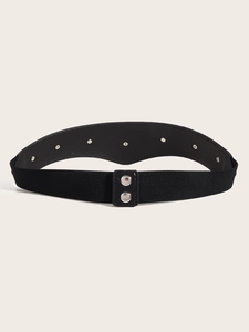 Detailed macro view of black elastic waist belt with silver metal buttons and rivets