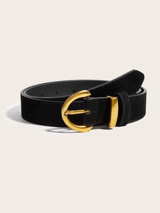 Vintage black suede wide belt with an antique gold horseshoe buckle on light background
