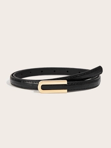 Close-up of black crocodile pattern thin leather belt with a minimalist golden U-shaped buckle