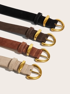 Detail of suede leather belts with gold D-buckles in black brown tan and beige