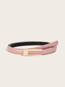 Detail of pink croc-embossed leather belt with a minimalist gold rectangular buckle