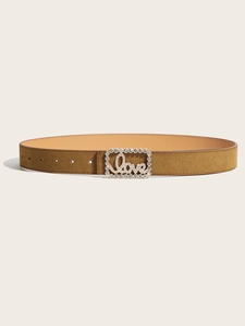 Detailed macro of brown suede belt with sparkling rhinestone buckle and Love metal accent