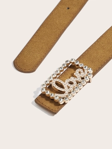 Close-up of brown suede belt with a gold crystal buckle featuring Love lettering