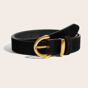 Close-up of a wide vintage black suede belt with a golden horseshoe-style metal buckle