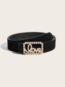 Macro shot of black suede belt with golden rhinestone Love buckle and crystal frame