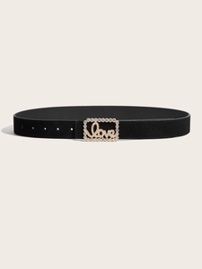 Detailed macro of vintage black suede belt featuring a diamond-encrusted Love buckle