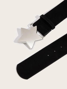 Detail of black suede belt featuring a polished silver star-shaped metal buckle closure