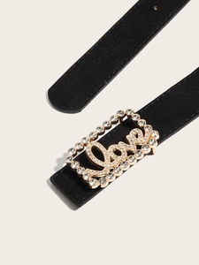 Close-up of black matte leather belt featuring a golden Love buckle with rhinestones