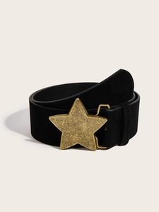 Detail of a vintage black suede belt featuring a large brushed gold star-shaped buckle