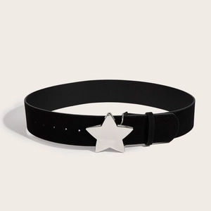 Vintage wide black suede belt for women with a metallic silver star buckle on beige background