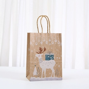 Close-up of Christmas kraft paper gift bag with reindeer and snowflake prints and rope handles
