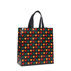 Waterproof non-woven shopping bag with colorful heart prints and black woven handles