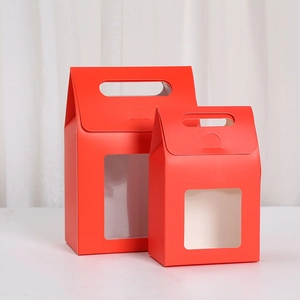 Detail of red cardboard gift boxes with transparent PVC window and handle for presentation
