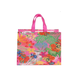 Pink non-woven floral shopping bag with tropical hibiscus and palm leaf patterns