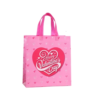 Sac cadeau rose en non-tissé avec motifs de cœurs et imprimé Happy Valentine's Day