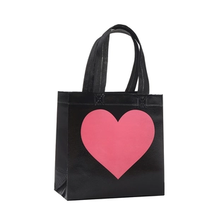 Black non-woven Valentine gift bag with pink heart pattern and reinforced handles