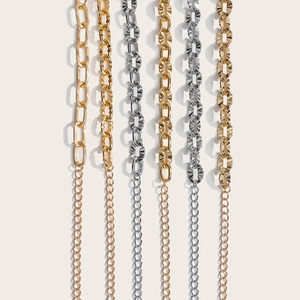 Close-up of various gold and silver hollow metal chains for elegant dress belts