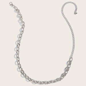 Detailed macro view of silver metallic hollow waist chain with lobster clasp and bead detail