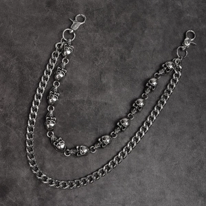 Detail of a punk style double-layered trouser chain with skull motifs and Cuban links
