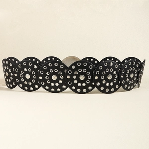 Detailed view of western style wide leather belt with silver grommets and metal studs