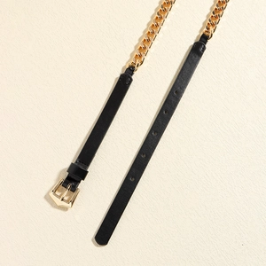 Detail of black leather belt with golden chunky chain and polished pin buckle closure