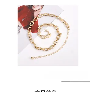 Detail of chunky gold metal waist chain with adjustable links on a fashion magazine