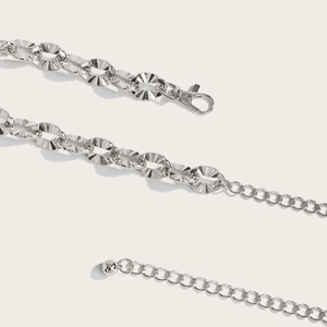 Detail of silver hollow metal waist chain showing lobster clasp and adjustable links