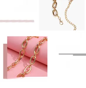 Detail of adjustable gold metal chain belt with lobster clasp and chunky alloy links