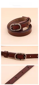 Macro detail of dark brown leather skinny belt with oval vintage metal buckle and oil-edge finish