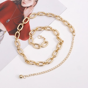 Detailed view of bold gold link chain body belt with lobster clasp and adjustable metal ball
