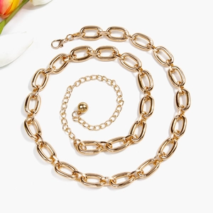 Detailed view of polished gold multi-layer waist chain with lobster clasp and ball pendant