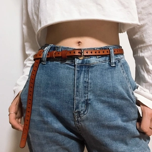 Women's brown leather belt with heart-shaped cutouts and vintage silver pin buckle