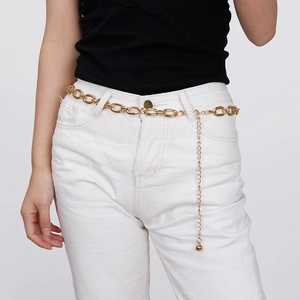 Detail of chunky gold aluminum chain waist belt with pendant on white denim jeans