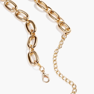 Detail of gold aluminum body chain featuring sturdy links, lobster clasp and extender