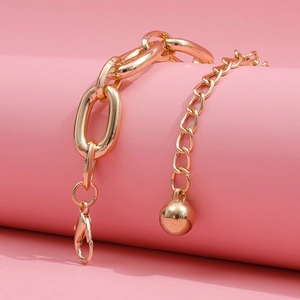 Close-up of chunky gold-tone aluminum chain with adjustable clasp and metal bead detail