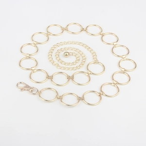 Detail of light gold chain belt with metal rings, lobster clasp and small round ball charm