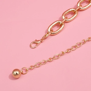 Exaggerated gold aluminum waist chain with large oval links and a solid metal ball charm