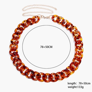 Detail of leopard print acrylic chain belt with gold metal extender and lobster clasp