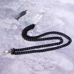 Detail shot of a black double-layered Cuban link pants chain with silver metal hooks