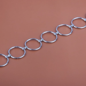 Detailed macro view of silver circular metal links connected with textured ring clasps